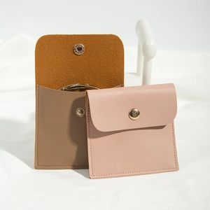 Detail of coffee and pink PU leather jewelry pouches with secure metal snap buttons