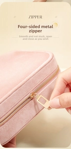 Detail of a smooth golden metal zipper on a pink velvet jewelry organizer box