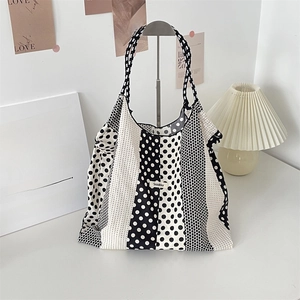 Detail of floral tote bag with black and white polka dots and stripe pattern