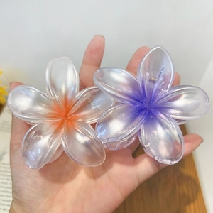 Elegant plumeria flower hair claws with pearlescent finish in white and purple tones