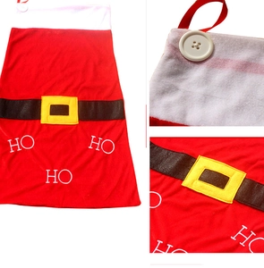 Detail of red velvet Christmas drawstring gift bag with black belt and HO HO HO print