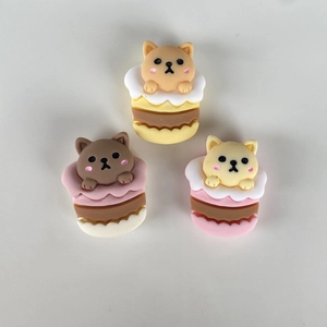 Close-up of three cute resin animals on colorful cupcakes for DIY phone case accessories