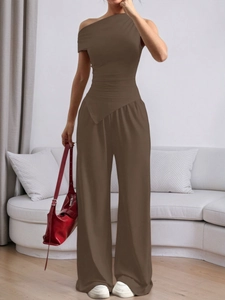 Women's dark brown two-piece set featuring one-shoulder top and high-waisted trousers