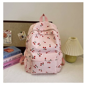 Detailed view of pink corduroy backpack with cherry print in a cozy ins-style study setting