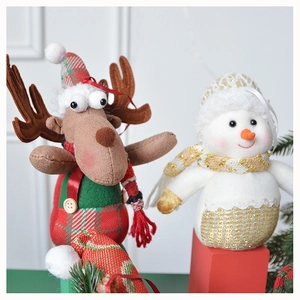 Detail of plush Christmas reindeer and snowman figurines with knitted fabrics and felt