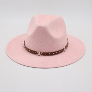 Pink wide brim fedora hat with star studded brown leather band on grey background