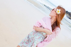 Close-up of light pink translucent floral shawl paired with a beach holiday dress