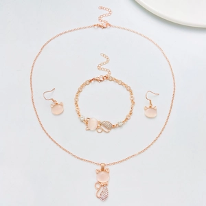 Flat lay of cat opal jewelry set with necklace bracelet and earrings in rose gold