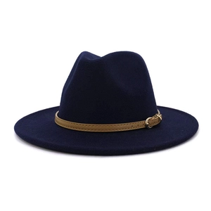 Detail of dark blue wool fedora hat featuring khaki leather band and gold buckle accent