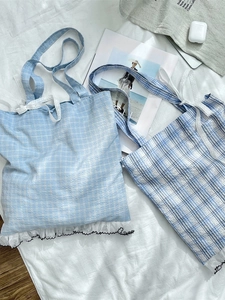 Light blue plaid canvas tote bag with white lace bow detail and ruffle trim
