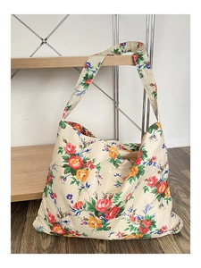 Detailed close-up of vintage floral canvas tote bag with red and orange flowers