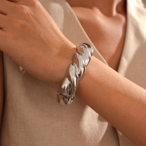 Detailed view of silver thick twisted rope texture on a minimalist open metal bangle cuff