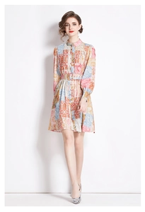 Detail of vintage patchwork print dress with long sleeves and matching square buckle belt