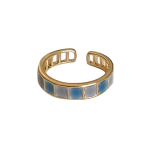 Minimalist gold adjustable ring with blue and grey checkerboard enamel patterns