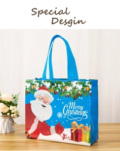 Detail of blue Christmas non-woven gift bag with Santa Claus print and waterproof texture
