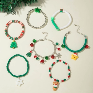 Close-up of Christmas charm bracelets with Santa, reindeer and snowflake pendants