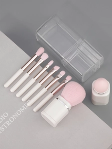 Detail shot of 8-in-1 pearlescent makeup brush set with pink bristles and storage box