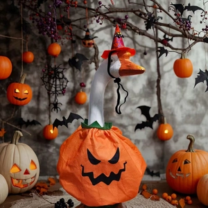 Halloween pumpkin goose costume with wizard hat and festive holiday decor backdrop
