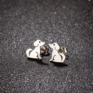 Polished silver puppy dog silhouette stud earrings with butterfly backings on black background