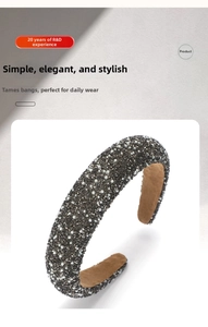Detail of dark grey sponge headband featuring grey rhinestones and white pearls with velvet lining