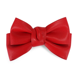 Close-up of a red PU leather bow hair clip showing elegant texture and 3D shape