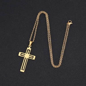Macro view of gold stainless steel hollow cross pendant with polished geometric layering