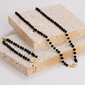 Set collana e bracciale di perle di vetro nere con ciondolo albero della vita oro