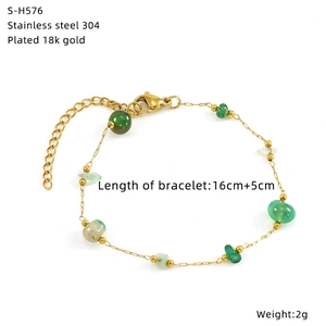 Detail of 18k gold plated titanium steel bracelet with glass beads and natural stones
