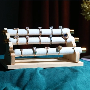 Three-tier luxury white velvet ring display stand with a solid wooden base for jewelry