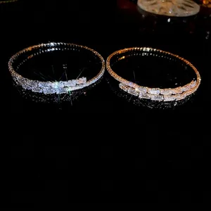Elegant gold and silver open bracelets featuring sparkling cubic zirconia on black background