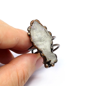 Close-up of handmade electroplated ring with natural purple agate geode crystal