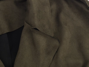 Gros plan du manteau en daim vert militaire montrant les coutures et la texture du tissu