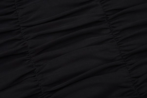 Detail of black mesh fabric showing elegant pleated texture and semi-sheer material