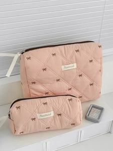 Set of pink quilted cosmetic bags with strawberry bow embroidery and ribbon zippers