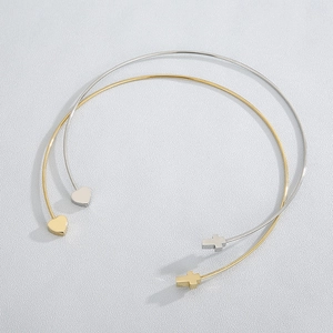 Top view of gold and silver open bangles featuring heart and cross charms in steel