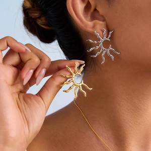 French vintage 18k gold and silver geometric hollow sun earrings shown on a model