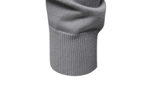 Close-up of grey knitted cardigan showing detailed ribbed cuffs and texture