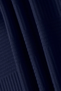 Detail of navy blue knitted fabric showing vertical ribbing and cross-stitch texture