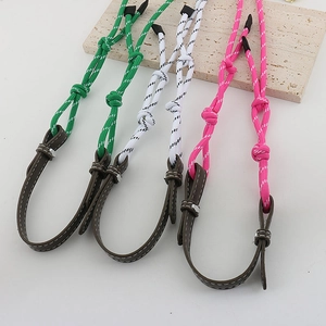 Detail of colorful woven eyeglass chains with leather loops and metallic fasteners