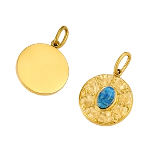Detailed close-up of a vintage round gold pendant with hand-hammered texture and blue stone