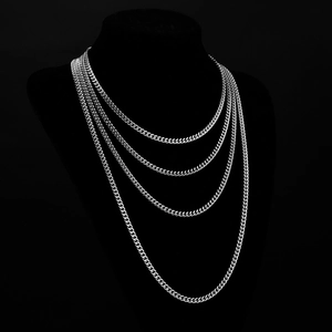 Set of four silver stainless steel Cuban link necklaces in various lengths on a black bust