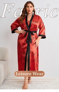 Macro shot of red satin pajama set with black heart print and contrasting trim detail