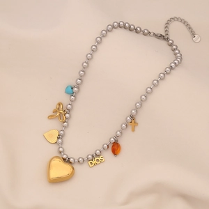 Detail of stainless steel necklace with gold heart, cross, and blue beads charms