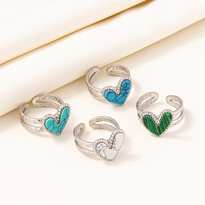 Detail of adjustable open rings with heart-shaped turquoise and malachite stones