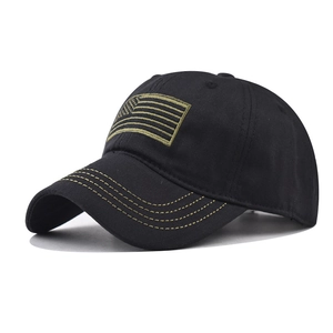 Close-up of US flag embroidery and contrast yellow stitching on black baseball cap