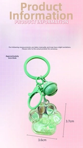 Detail view of light green quicksand cat paw keychain with dimensions 3.6 by 3.7 cm