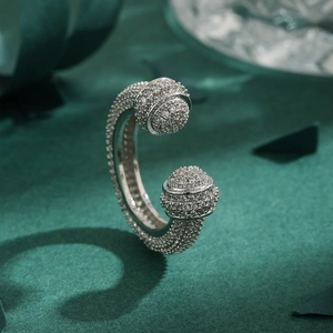 Silver open C-shape ring featuring full white zircon pavé on a dark green background