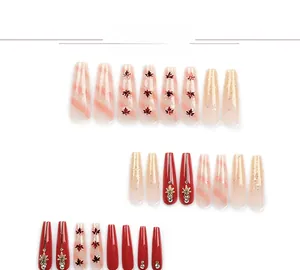 Detailed view of red maple leaf press-on nails with glitter and rhinestone accents