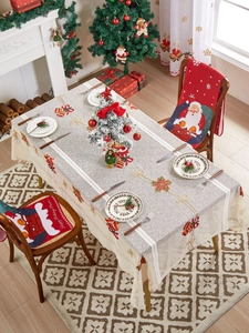 Detail of Christmas tablecloth and chair covers with bell embroidery and Santa motifs