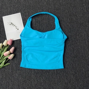 Macro shot of seamless bright blue halter yoga top with center chest ruched detail